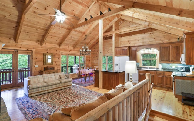 living room with high vaulted ceiling, wooden walls, light hardwood / wood-style floors, wooden ceiling, and beam ceiling