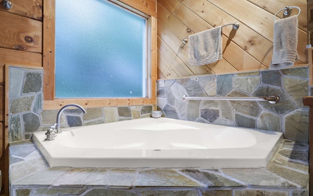 bathroom featuring wooden walls