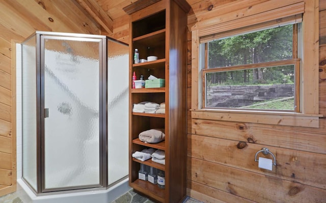 bathroom featuring walk in shower and wood walls