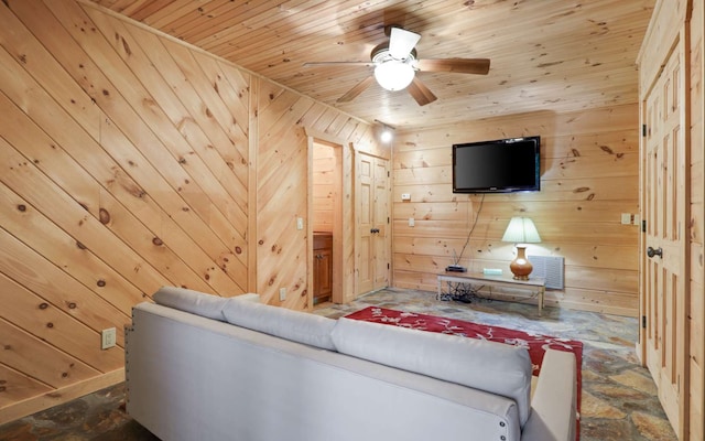 living room featuring ceiling fan, wooden walls, and wood ceiling