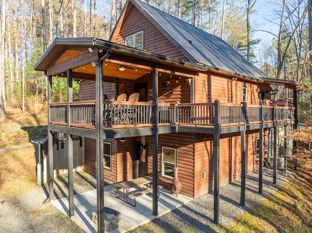 rear view of house with a patio area and a deck