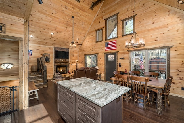 kitchen with pendant lighting, dark hardwood / wood-style floors, high vaulted ceiling, and a healthy amount of sunlight