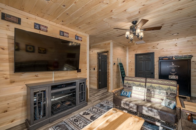 living room featuring wooden walls, ceiling fan, wood ceiling, and hardwood / wood-style flooring