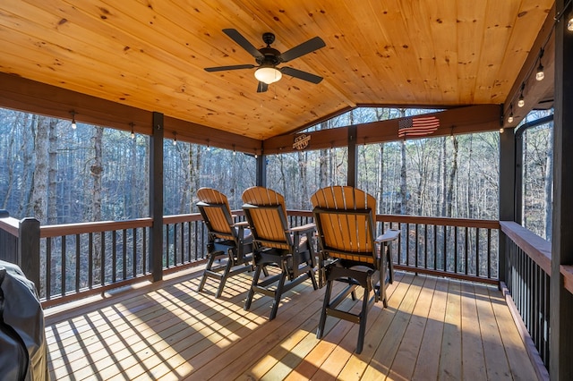 sunroom / solarium with ceiling fan, wooden ceiling, and lofted ceiling