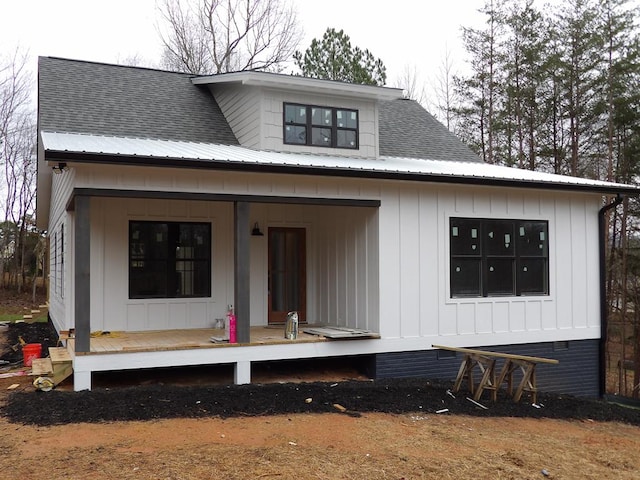 rear view of property with a porch