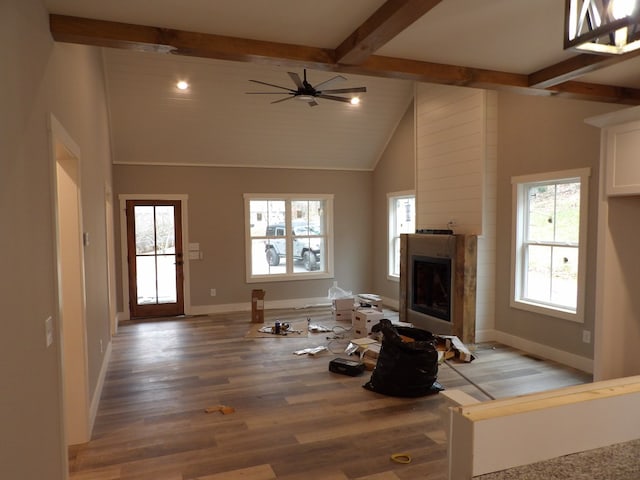 unfurnished living room featuring ceiling fan, beamed ceiling, high vaulted ceiling, and hardwood / wood-style flooring