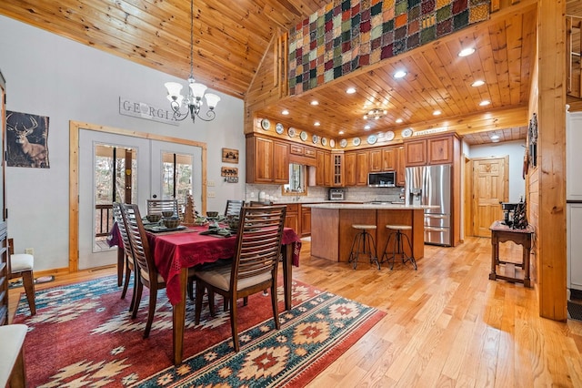 dining room with high vaulted ceiling, wooden ceiling, french doors, and light wood-type flooring