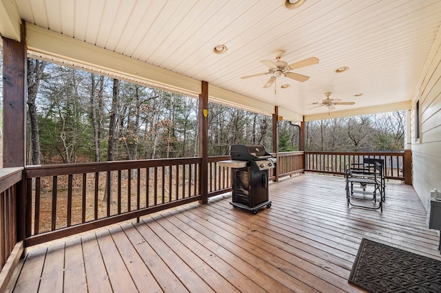 wooden deck with grilling area and ceiling fan