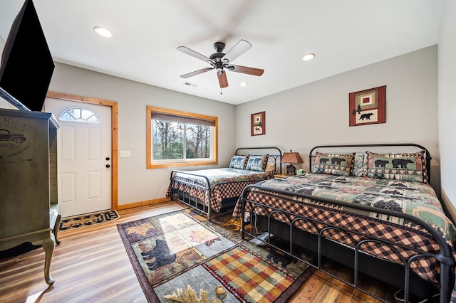 bedroom with hardwood / wood-style floors and ceiling fan