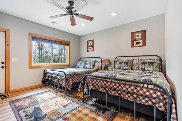 bedroom featuring hardwood / wood-style flooring and ceiling fan