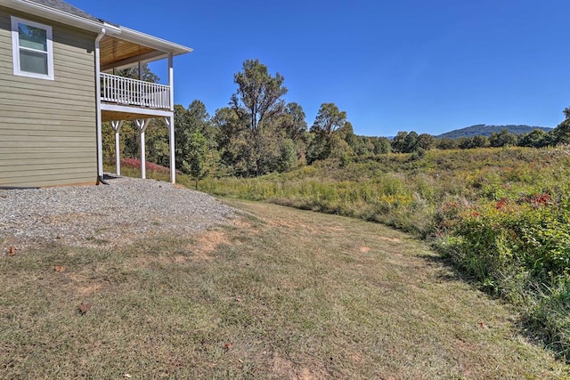 view of yard featuring a balcony