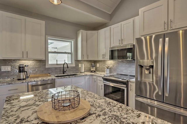 kitchen with white cabinets, appliances with stainless steel finishes, and sink