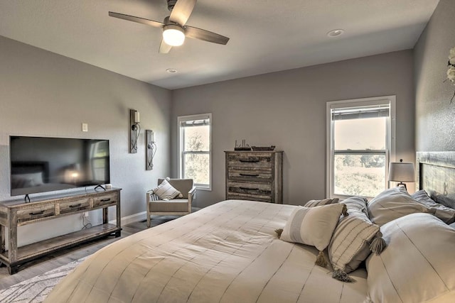 bedroom with ceiling fan and light wood-type flooring