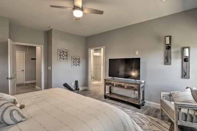 bedroom with ensuite bath, ceiling fan, and hardwood / wood-style flooring