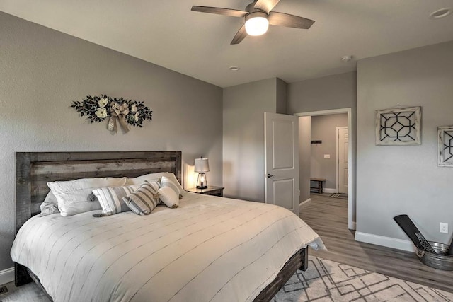 bedroom with hardwood / wood-style floors and ceiling fan