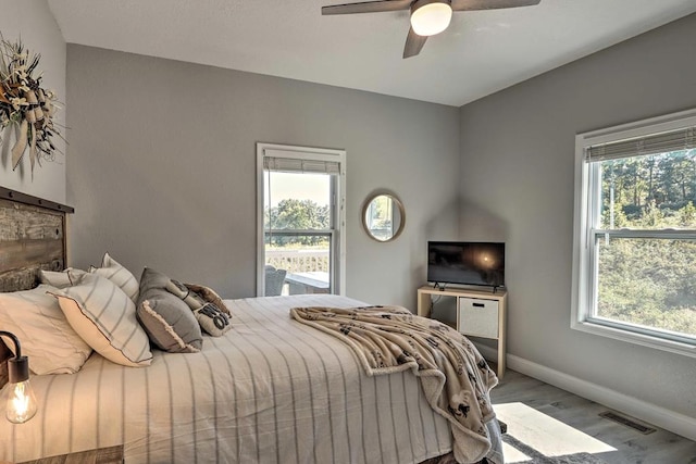 bedroom with wood-type flooring and ceiling fan