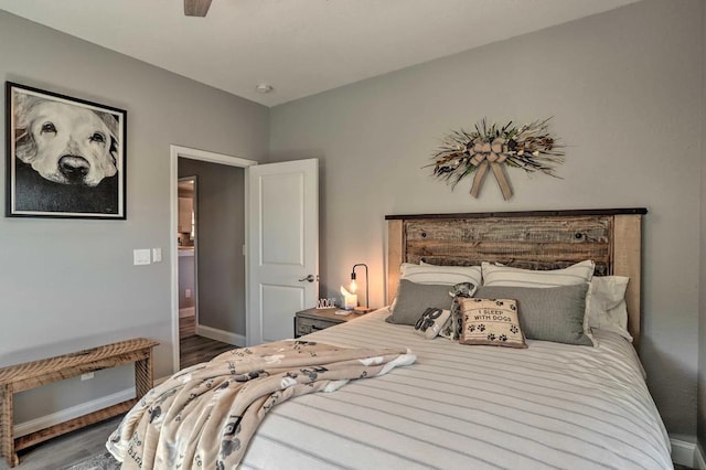 bedroom featuring dark hardwood / wood-style flooring and ceiling fan