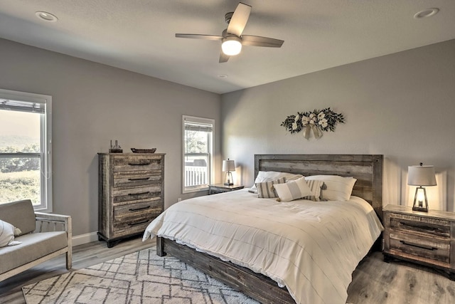 bedroom featuring ceiling fan and light hardwood / wood-style floors