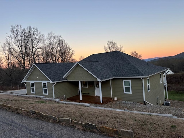 view of front of house with a shingled roof and covered porch