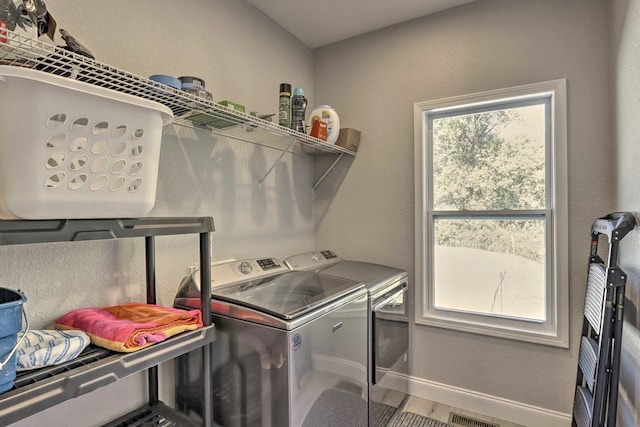 laundry room with hardwood / wood-style floors and washer and clothes dryer