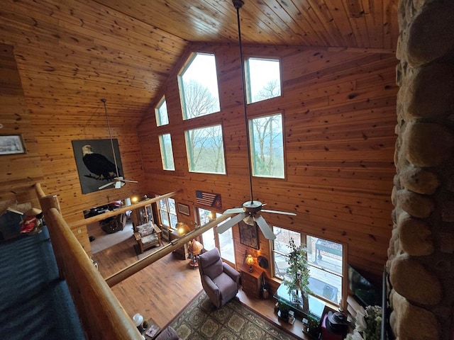 living room with wood-type flooring, high vaulted ceiling, ceiling fan, and wood ceiling