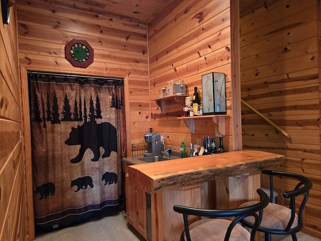 bathroom with wood ceiling and wooden walls