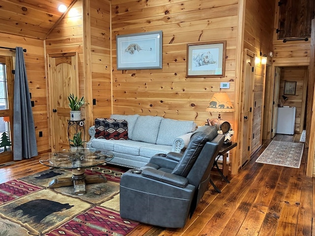 living room featuring wooden walls, vaulted ceiling, and dark wood finished floors