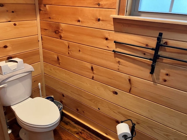 bathroom with toilet and wood finished floors