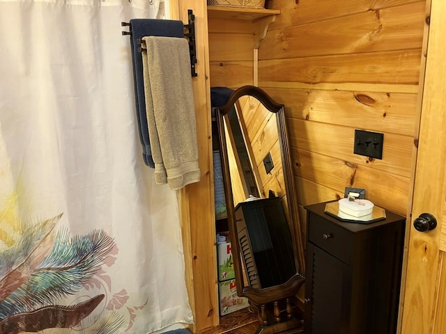 bathroom with wood walls