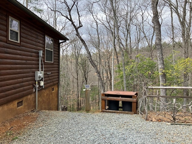 exterior space featuring crawl space and faux log siding