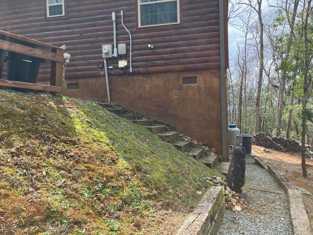 view of side of home with central AC unit and log veneer siding