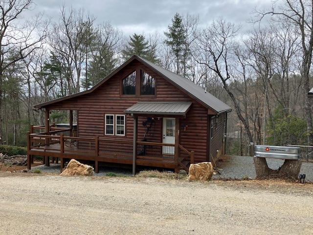 view of front facade featuring metal roof and log veneer siding