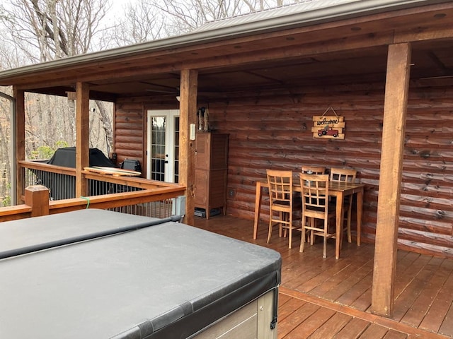 wooden deck with a hot tub
