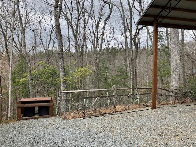 view of yard with a view of trees