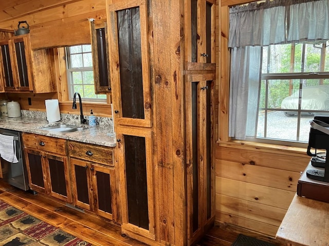 bathroom featuring a sink, wood walls, and hardwood / wood-style flooring