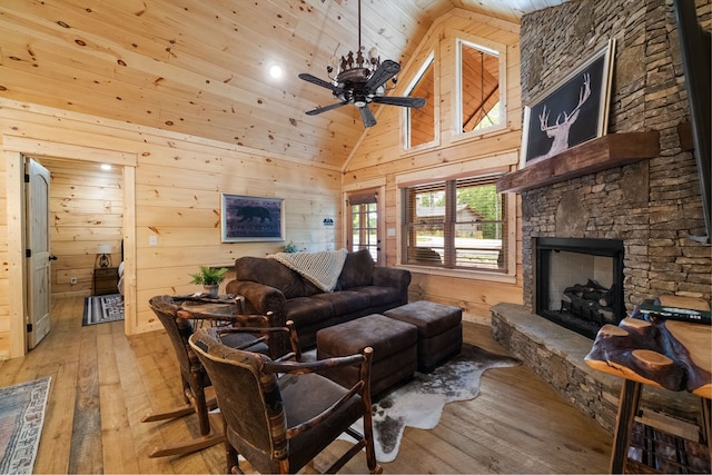 953 Lemmon Ln, Ellijay, GA 30540 - living area with wooden ceiling, light wood-type flooring, ceiling fan, a stone fireplace, and wood walls