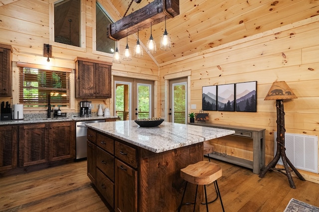 953 Lemmon Ln, Ellijay, GA 30540 - kitchen featuring dishwasher, hardwood / wood-style floors, wood walls, a breakfast bar, and a center island