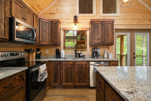 953 Lemmon Ln, Ellijay, GA 30540 - kitchen with stainless steel appliances, a sink, light wood-style flooring, lofted ceiling, and light stone counters