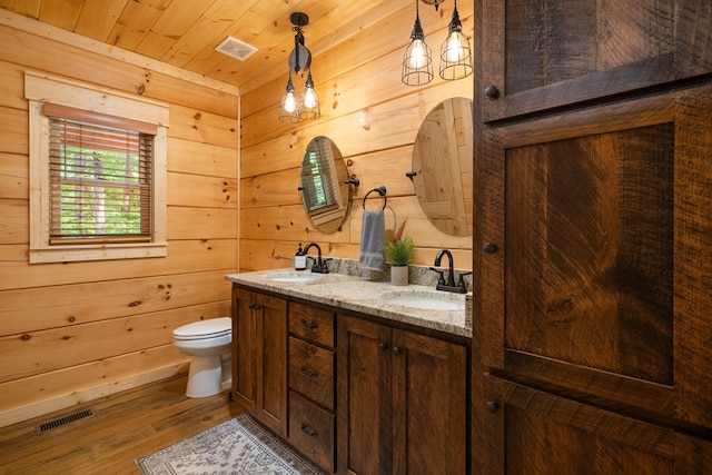 953 Lemmon Ln, Ellijay, GA 30540 - full bathroom featuring toilet, wood finished floors, double vanity, wooden ceiling, and wooden walls