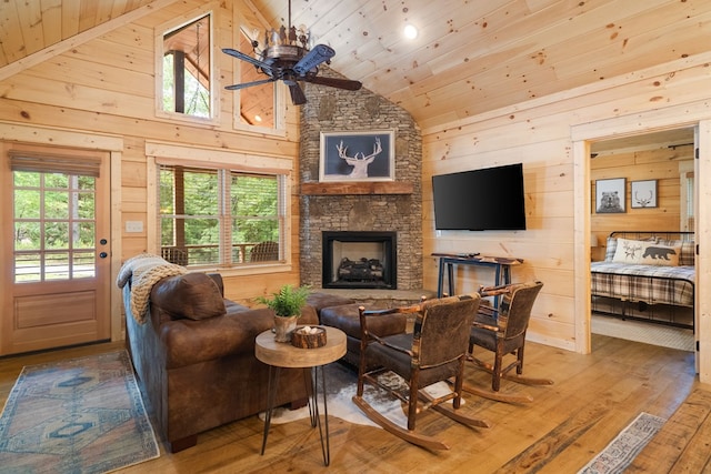 953 Lemmon Ln, Ellijay, GA 30540 - living area featuring wood ceiling, wooden walls, a ceiling fan, wood finished floors, and a fireplace