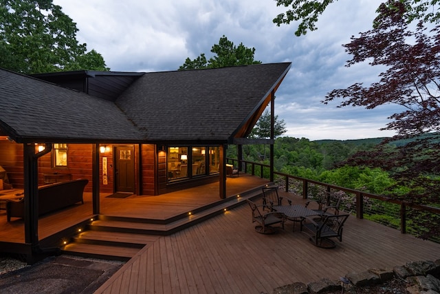 wooden terrace with outdoor dining space