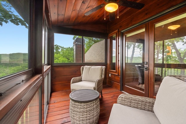 sunroom featuring ceiling fan and plenty of natural light