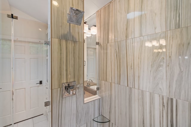 bathroom featuring lofted ceiling, a shower, and tile patterned floors