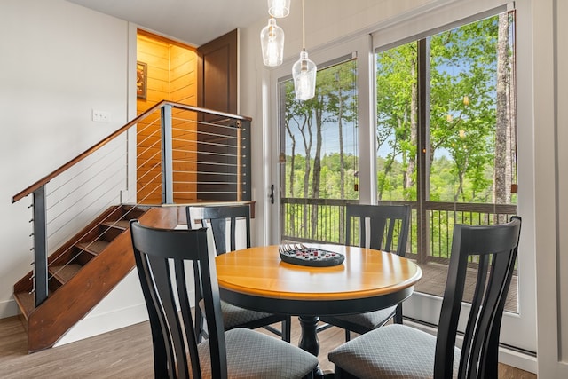 dining room featuring stairs and wood finished floors