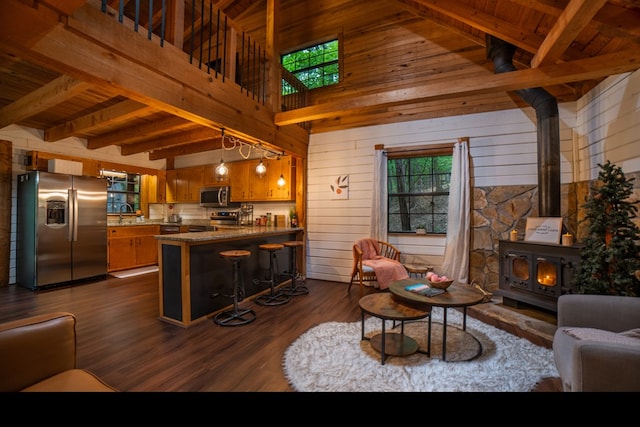 living room featuring wooden ceiling, dark wood-type flooring, and a wood stove