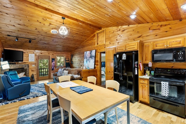 dining area with wood ceiling, vaulted ceiling, a fireplace, wood walls, and light hardwood / wood-style flooring