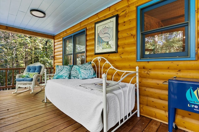 bedroom featuring wood ceiling, dark hardwood / wood-style flooring, and log walls