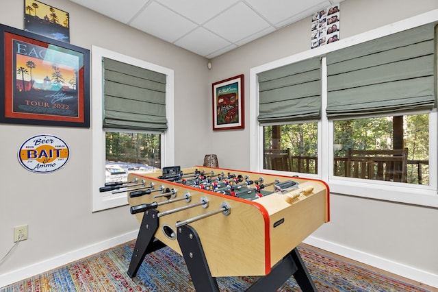 rec room featuring a drop ceiling and a wealth of natural light