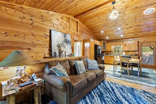 living room with beam ceiling, light wood-type flooring, wood walls, and wood ceiling