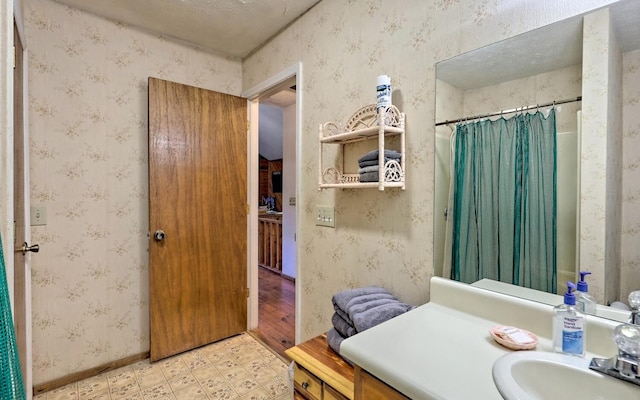 bathroom featuring vanity and a textured ceiling